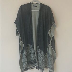 Long shawl with open front and armholes.